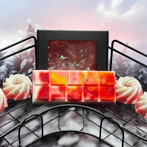 Christmas Wax Melt Gift Set with handmade soap swirls and festive snap bars in red and white, displayed in a holiday-themed snowy background.